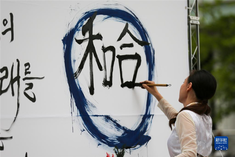 5月30日，在韓國首爾舉辦的“中日韓合作之日”慶?；顒?dòng)中，表演者進(jìn)行中日韓精神——2023年度漢字“和合”書法表演。新華社記者 王益亮 攝