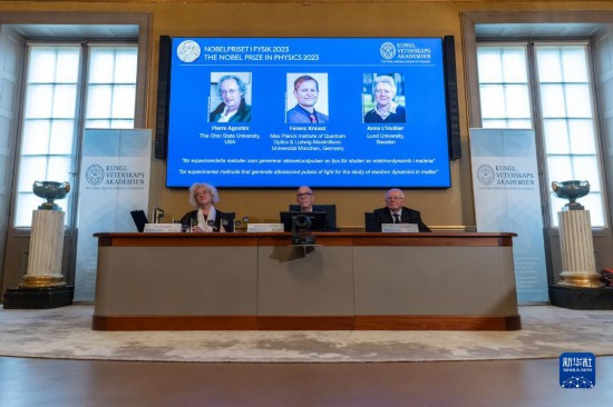 10月3日，在瑞典斯德哥爾摩舉行的2023年諾貝爾物理學獎公布現(xiàn)場，屏幕上顯示獎項得主皮埃爾·阿戈斯蒂尼（左）、費倫茨·克勞斯（中）和安妮·呂利耶的照片。新華社發(fā)（魏學超攝）