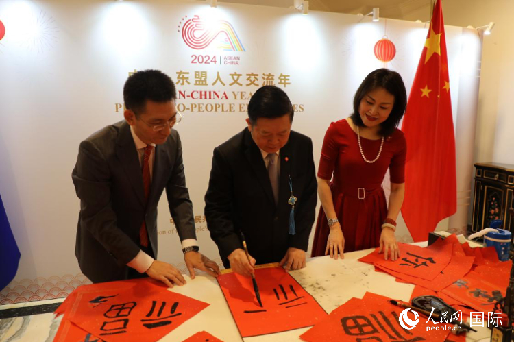 東盟秘書長(zhǎng)高金洪（中）在活動(dòng)現(xiàn)場(chǎng)寫福字。人民網(wǎng)記者曹師韻攝