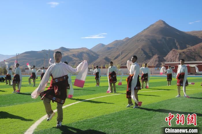 圖為青海師范大學(xué)附屬玉樹實(shí)驗(yàn)學(xué)校學(xué)生在綠茵場(chǎng)跳起囊謙古舞—卓根瑪。　程雨 攝