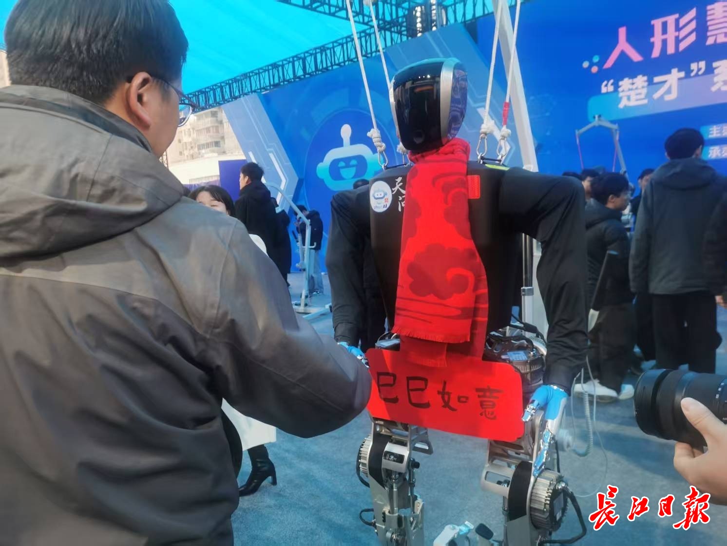 “天問”人形機(jī)器人和參觀市民握手，互致新年快樂。 長江日報(bào)記者陳永權(quán) 攝