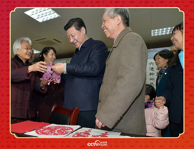 2015年2月15日，習(xí)近平在西安市雁塔區(qū)電子城街道二〇五所社區(qū)服務(wù)中心欣賞社區(qū)居民的剪紙作品。