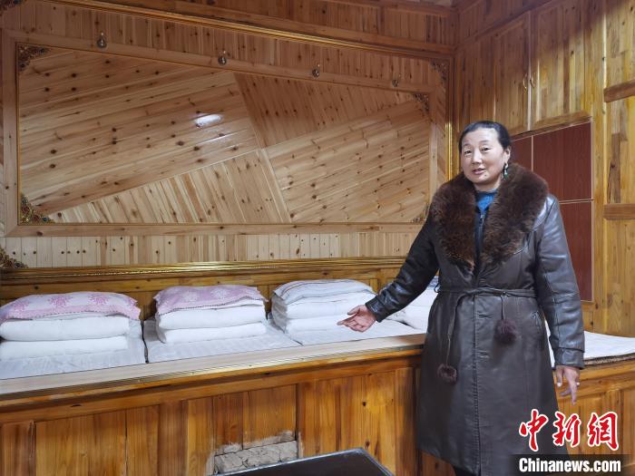 圖為德吉村村民鬧尖措介紹自家農(nóng)家樂?！∑钤鲚?攝