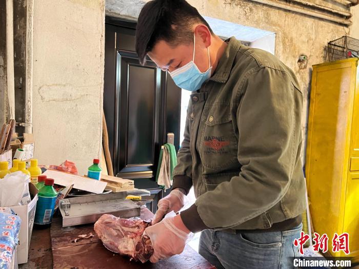 圖為雪豹“奶爸”史壽軍正在準(zhǔn)備投喂雪豹的食材?！●R銘言 攝