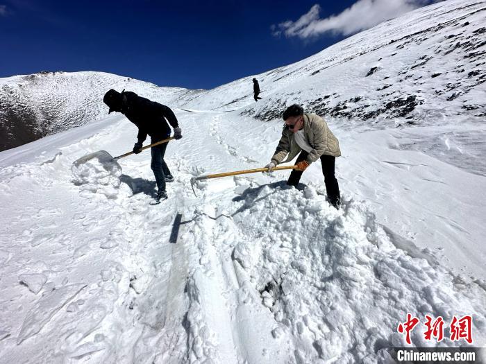 圖為生態(tài)管護人員在巡護道路上清雪?！《“瓦_杰 攝