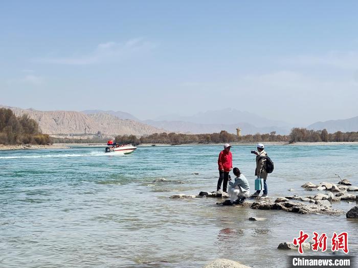 圖為游客在黃河岸畔游玩，并與黃河合影留念?！∑钤鲚?攝