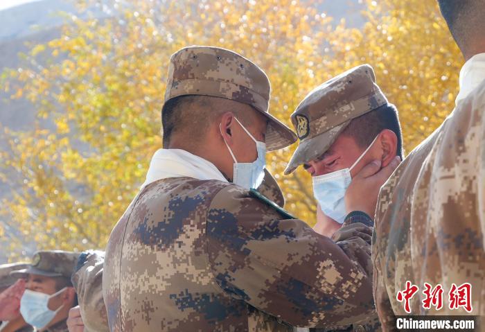 圖為什布奇邊防連退伍老兵與戰(zhàn)友相擁而泣，依依惜別?！⌒觳?攝