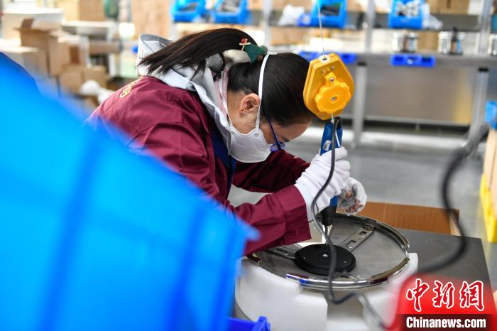 圖為工人正在組裝炊具?！∝暩聛硭?攝